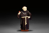 A WESTERN ROSEWOOD AND IVORY MONK FIGURE