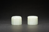 TWO WHITE JADE CARVED ARCHER'S RINGS