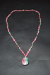 A TOURMALINE CARVED 'TWIN CATS' NECKLACE