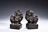 A PAIR OF STONE CARVED LION PAPER WEIGHTS