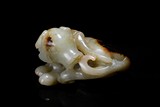 A WHITE AND RUSSET JADE CARVING OF DOG