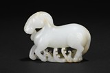 A WHITE JADE CARVING OF HORSE
