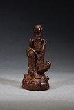 AN AGARWOOD CARVED FIGURE OF LUOHAN 