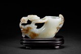 A WHITE JADE CARVED 'RAM HEAD' CUP