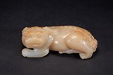 A WHITE AND RUSSET JADE CARVING OF QILIN