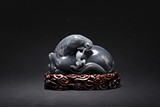 A BLACK AND WHITE JADE 'HORSE AND MONKEY' CARVING