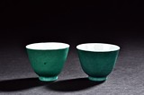A PAIR OF GREEN GLAZED CUPS