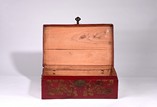 A LARGE RED RECTANGULAR LEATHER BOX