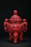 A LARGE CARVED CINNABAR LACQUER TRIPOD CENSER 