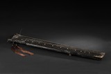 A LACQUERED WOOD GUQIN WITH INSCRIPTIONS