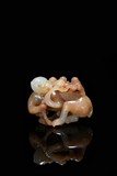 A WHITE AND RUSSET JADE MONKEY CARVING