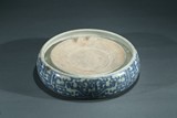 A LARGE BLUE AND WHITE ROUND INKSTONE