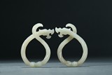 A PAIR OF WHITE JADE ROPE-TWISTED DRAGON PENDANTS