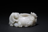 A WHITE JADE 'LUOHAN AND DRAGON' WASHER