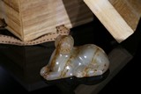 A WHITE AND RUSSET JADE RECUMBENT TIGER