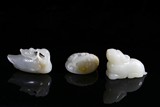 A SET OF THREE WHITE JADE CARVINGS
