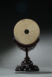 AN ARCHAIC JADE DISC WITH HARDWOOD STAND