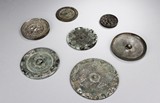 A GROUP OF SEVEN ARCHAIC BRONZE MIRRORS