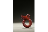 A RED JADE KNOTTED DRAGON PENDANT