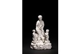 A BLANC-DE-CHINE FIGURE OF GUANYIN AND ATTENDANTS 
