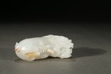 A WHITE JADE BUDDHIST LION CARVING