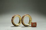 A PAIR OF GOLD-BEAD INLAID AGARWOOD BANGLES AND ARCHER'S RING