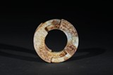 A WHITE AND RUSSET JADE RING CARVING 