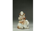 A WHITE JADE CARVING OF ARHAT ON LION