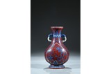 AN IRON RED GROUND BLUE AND WHITE 'DRAGON PHOENIX' VASE