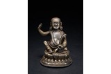 A SMALL SILVER FIGURE OF MILAREPA