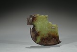 A GREEN AND RUSSET JADE 'AXE' PENDANT