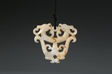 A CARVED JADE 'TWO DRAGONS' PENDANT