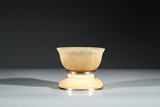 A YELLOW JADE CUPHOLDER AND HORN CARVED BOWL