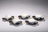 A SET OF FIVE BLUE AND WHITE CUPS WITH SILVER HOLDERS