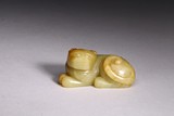 A YELLOW JADE CARVED RECUMBENT MYTHICAL BEAST 