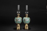 A PAIR OF BRONZE ENCASED FAMILLE ROSE OIL LAMPS
