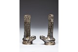 A PAIR OF SILVER TURTLE SUPPORTED STELES