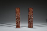 A PAIR OF ROSEWOOD CARVED 'RED CLIFF' WRIST RESTS
