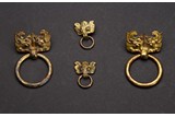 A GROUP OF FOUR GILT BRONZE MASK AND RING HANDLES