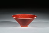 A RED GLAZED CONICAL BOWL