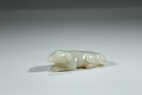 A WHITE JADE CARVING OF DOG