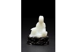 A CHINESE WHITE JADE CARVING OF SEATED GUANYIN