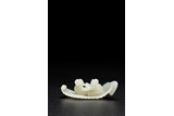 A WHITE JADE CARVING OF TWINS ON RAFT