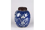 A BLUE AND WHITE REVERSE DECORATED 'PLUM BLOSSOM' JAR