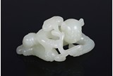 A WHITE JADE CARVING OF LINGZHI HOLDING BOY