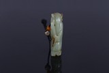 A CHINESE CELADON JADE FIGURE PENDANT